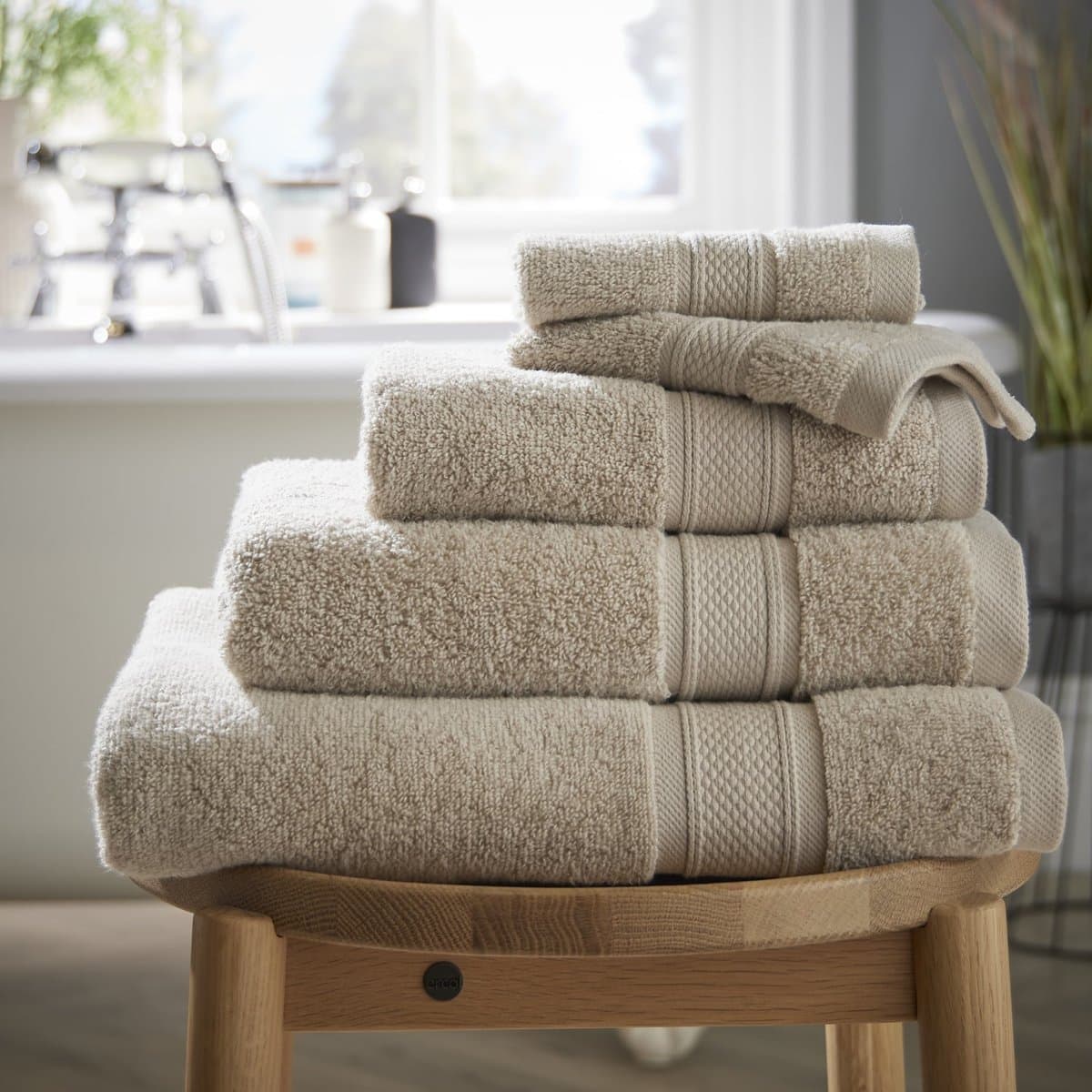 A folded set of stone cotton towels