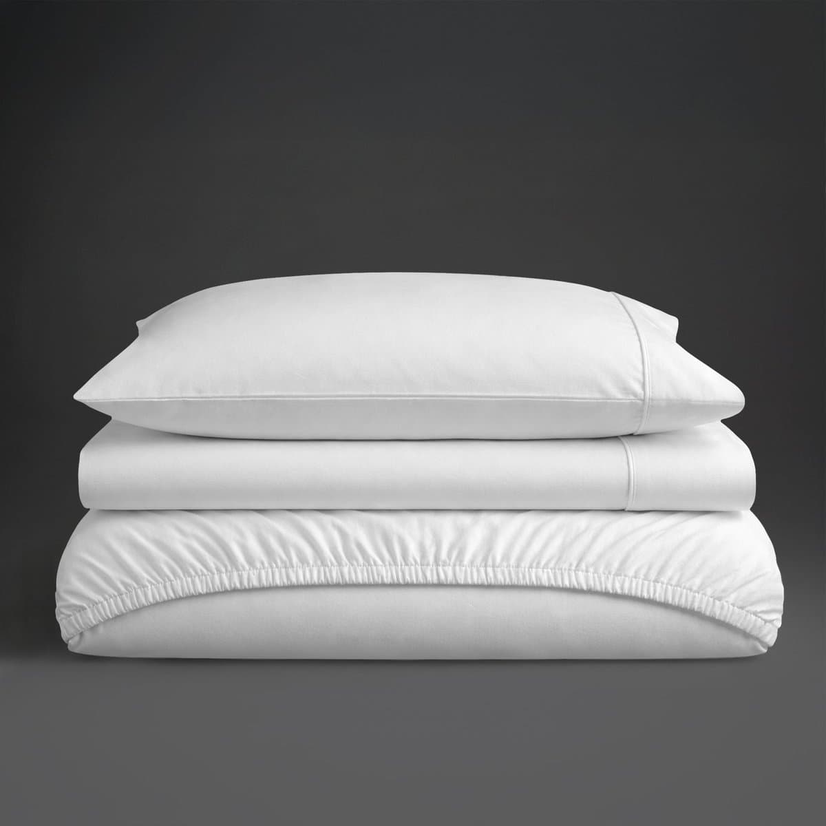 A folded white sateen cotton sheet set