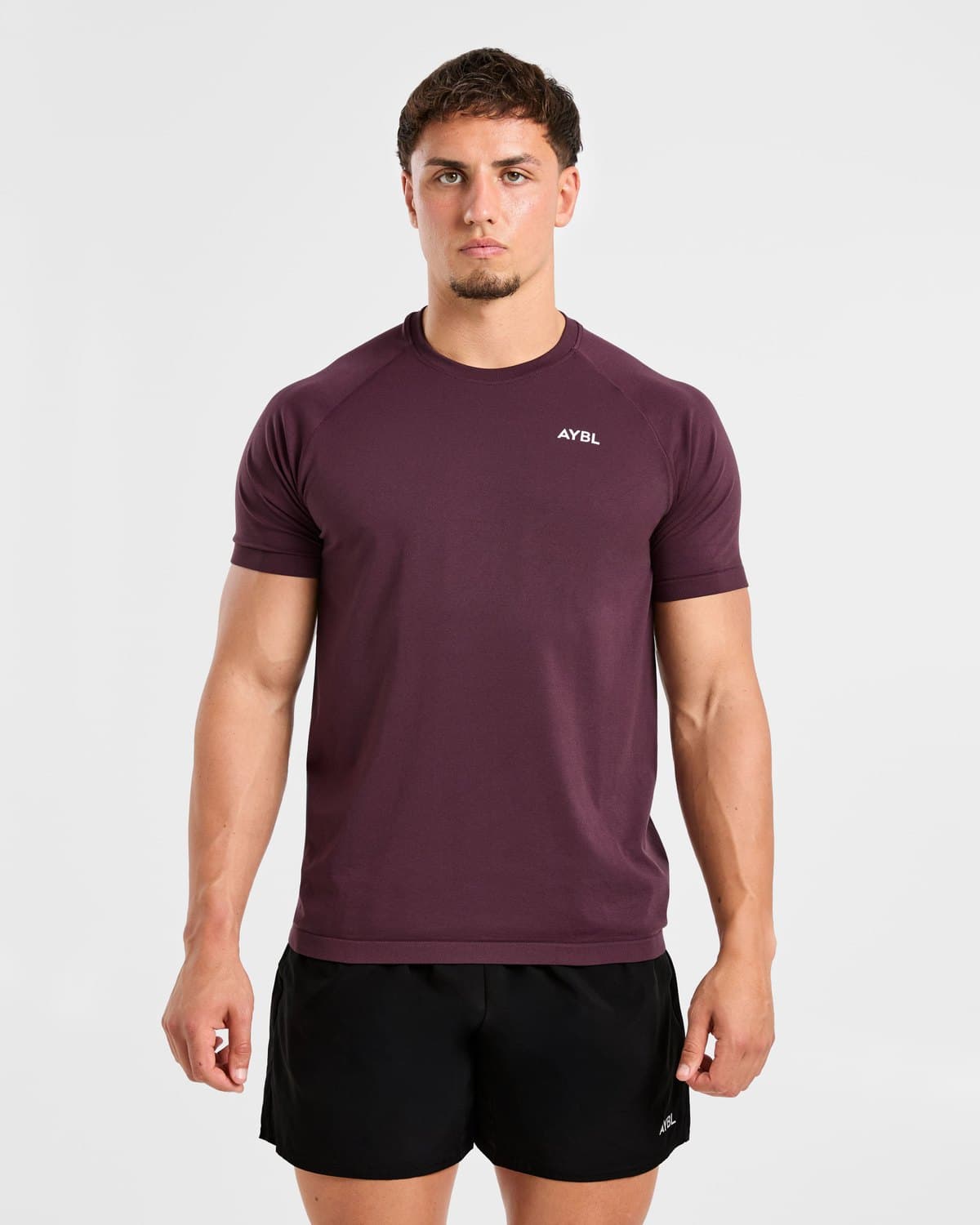 Male model in a deep plum seamless performance t-shirt